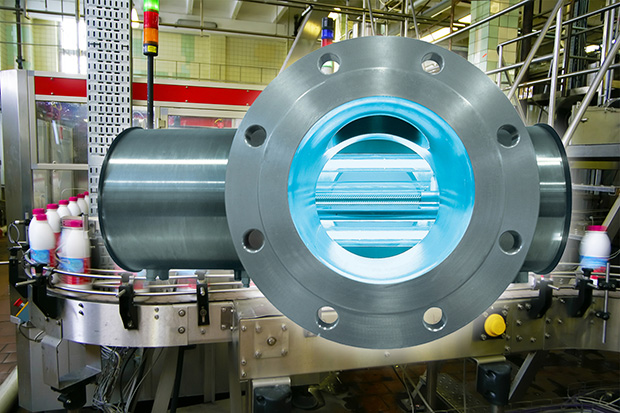 Milk bottles cross the PureLine UV technology unit for disinfection